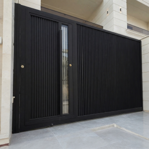 Ultra-Modern Matte Black Sliding Main Gate with Vertical Slatted Design and Integrated Pedestrian Door